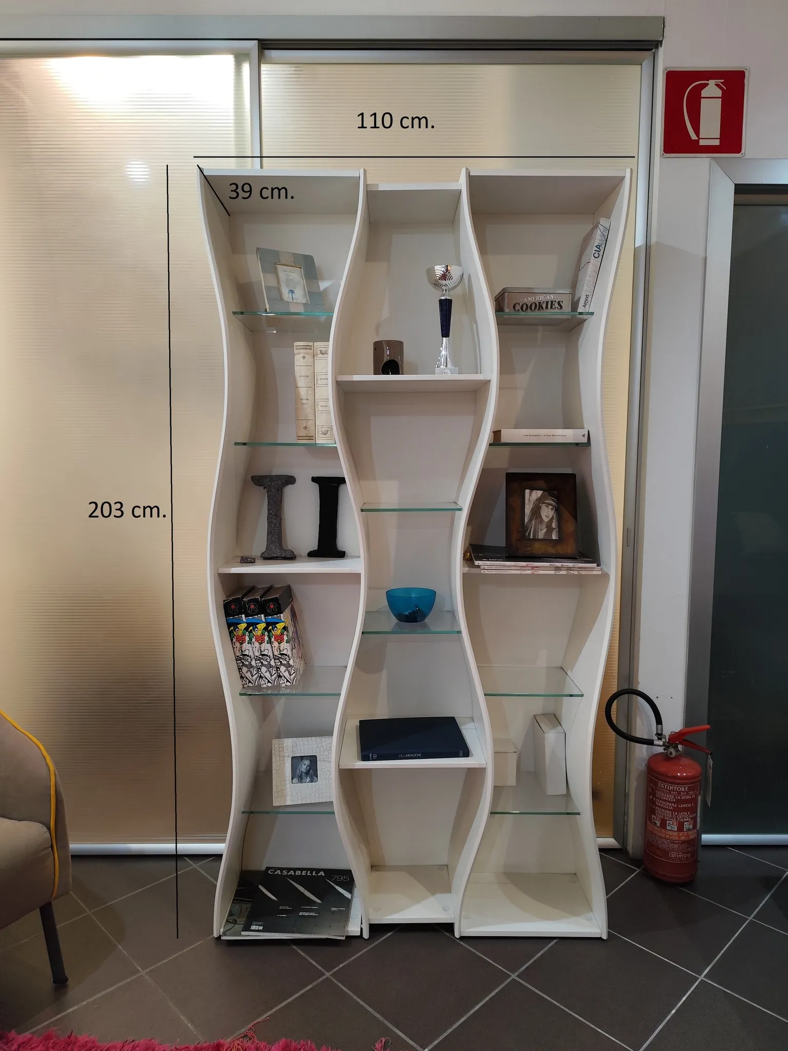 Libreria bianca ondulata con ripiani in vetro